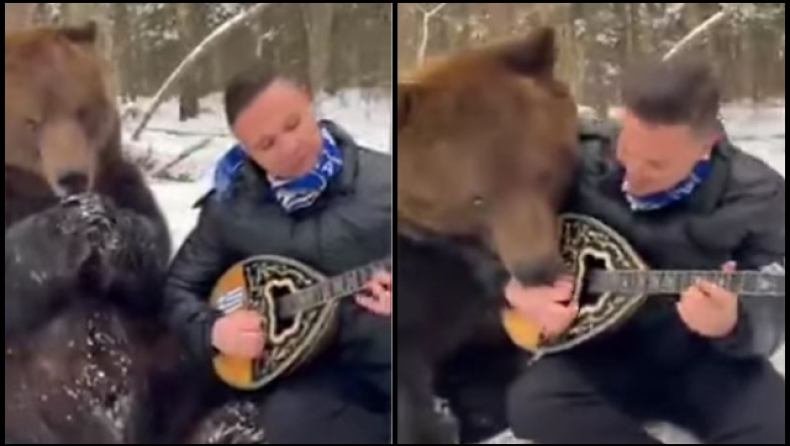 Λαρισαίος έγινε viral παίζοντας μπουζούκι στα χιόνι με μια αρκούδα δίπλα του να τον γλείφει (vid)