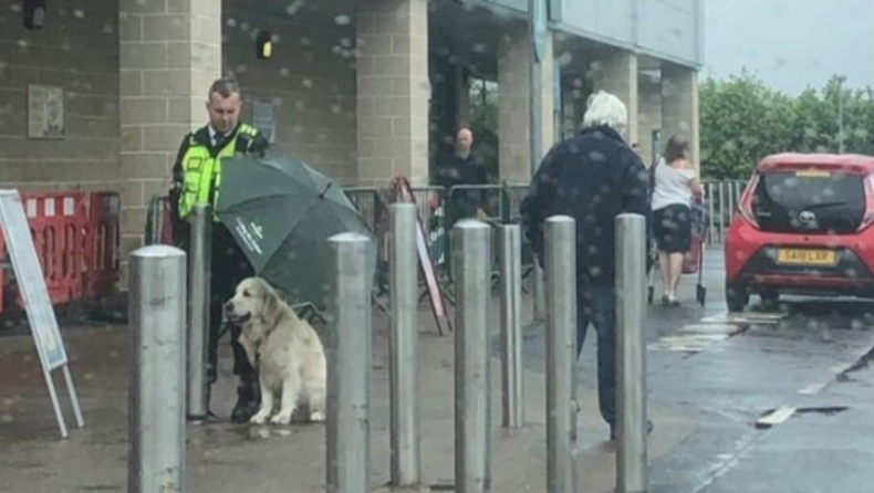 Φύλακας κρατάει ομπρέλα για να προστατεύσει σκύλο από την βροχή και γίνεται viral (pic)